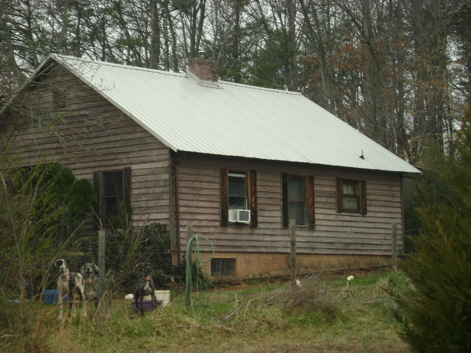 White metal roof on an old wood sided farmhouse, from a Metal Roof Installation job in Sun City Center